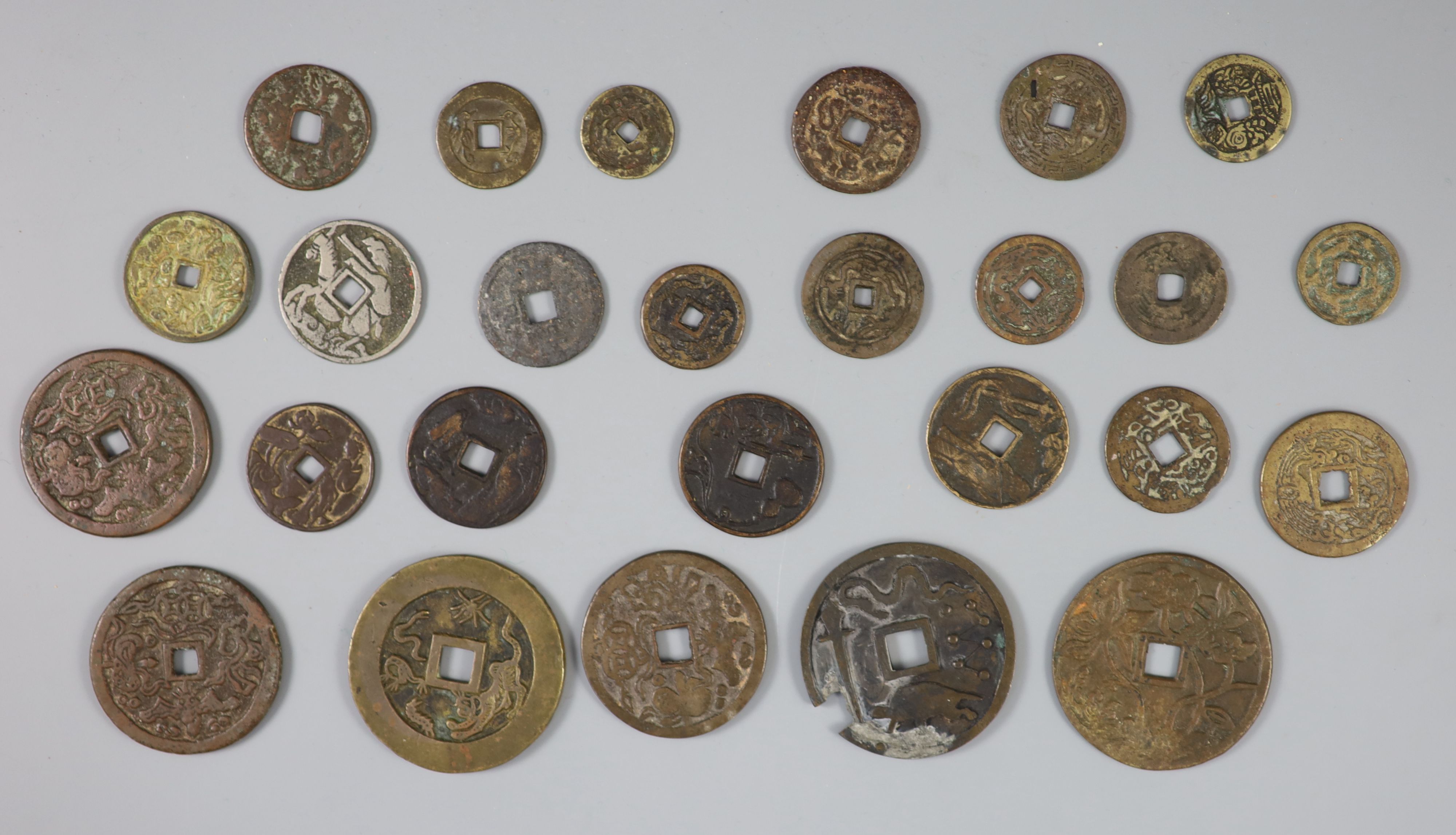 China, a group of 26 bronze or brass charms or amulets, Qing dynasty,